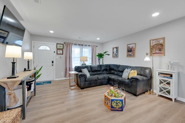 living room featuring recessed lighting, light wood-style flooring, and baseboards