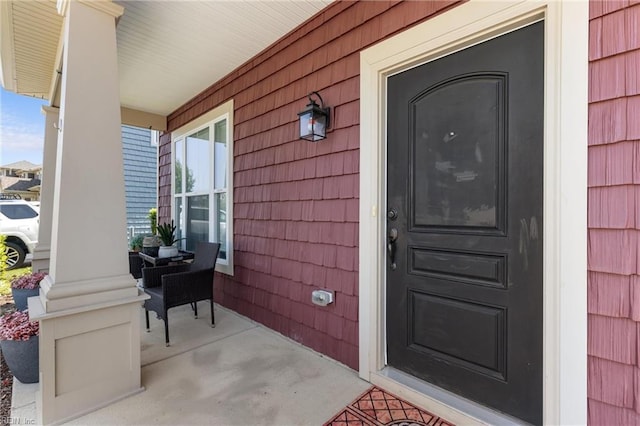 view of exterior entry featuring a porch