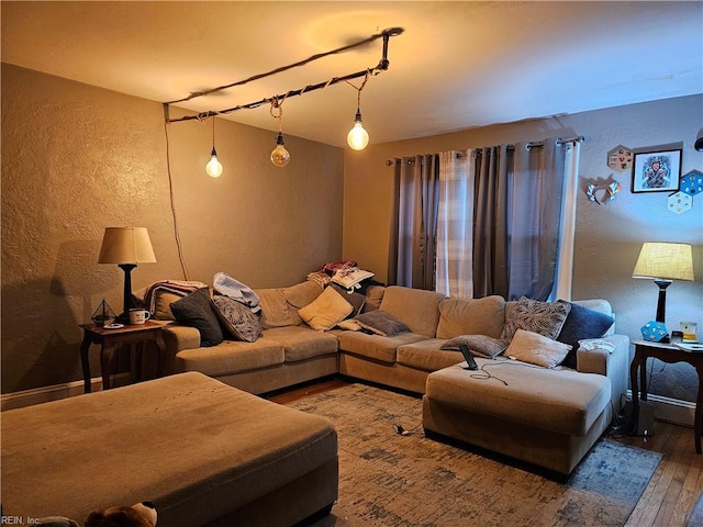 living area featuring hardwood / wood-style flooring and a textured wall