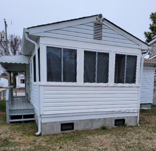 view of side of home featuring crawl space