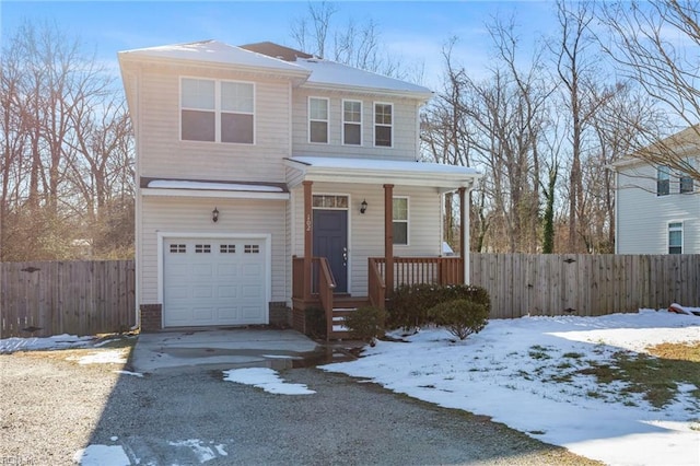 view of front facade featuring a garage and fence