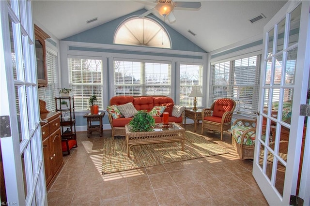 sunroom / solarium with vaulted ceiling, ceiling fan, and visible vents