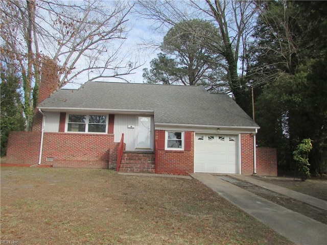 view of front of property featuring a chimney, brick siding, crawl space, and an attached garage