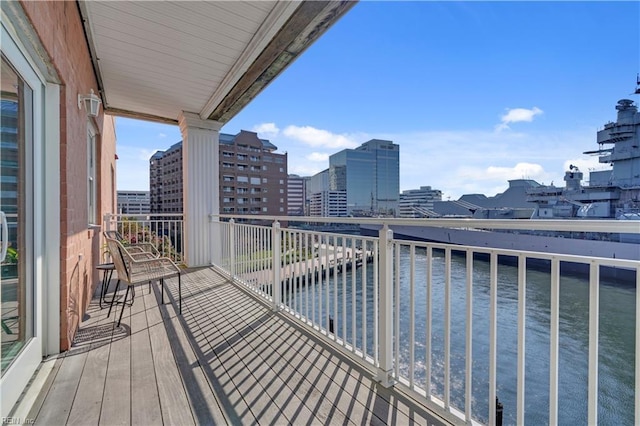 balcony with a water view and a city view