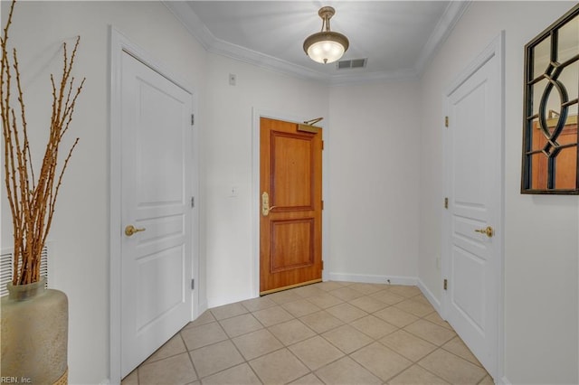 foyer entrance with visible vents, crown molding, and light tile patterned flooring