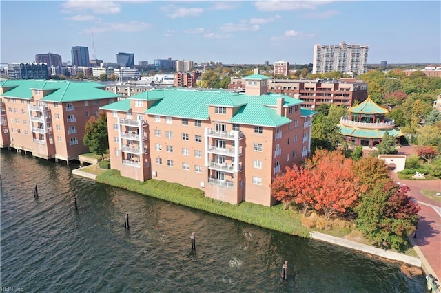 birds eye view of property with a view of city and a water view