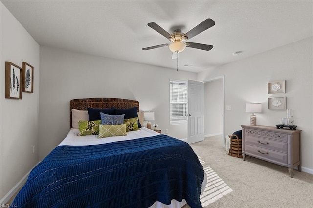 bedroom featuring ceiling fan, baseboards, and light colored carpet