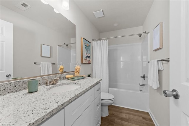 bathroom with shower / tub combo, visible vents, toilet, wood finished floors, and vanity