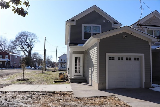 traditional-style home with a garage and concrete driveway