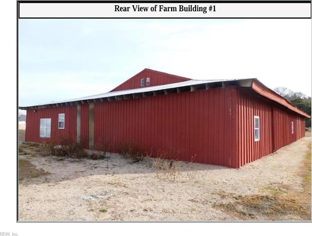 view of side of home featuring an outbuilding