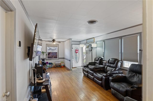 living area with light wood-type flooring and visible vents