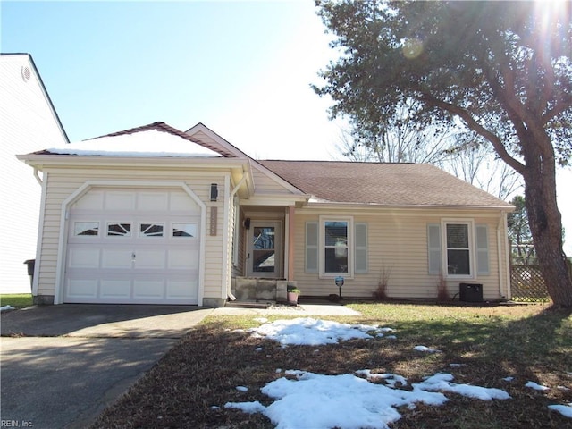 single story home with driveway and an attached garage