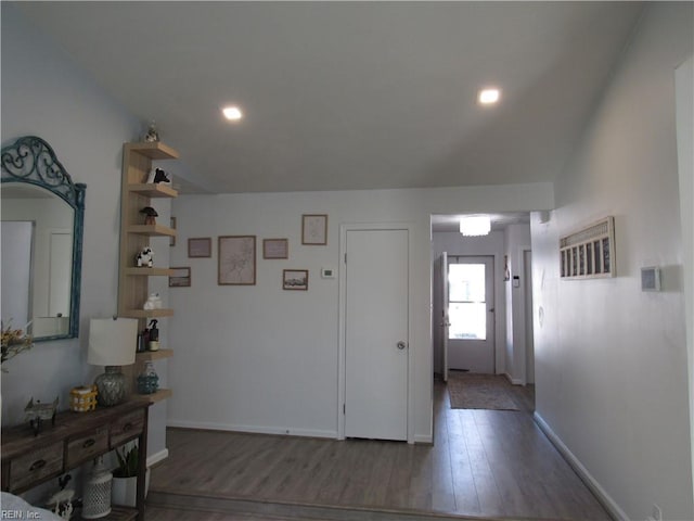 foyer entrance with recessed lighting, dark wood finished floors, and baseboards