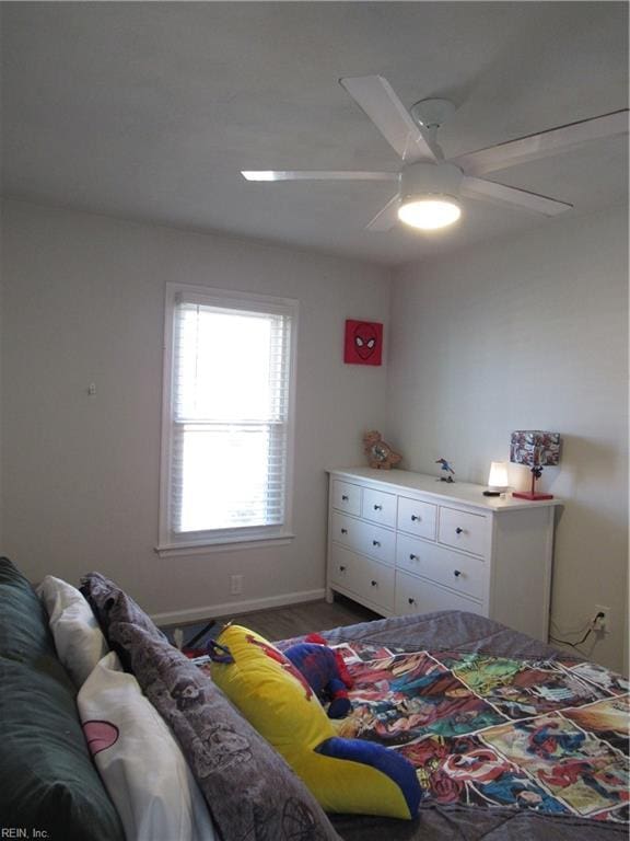 bedroom featuring ceiling fan and baseboards