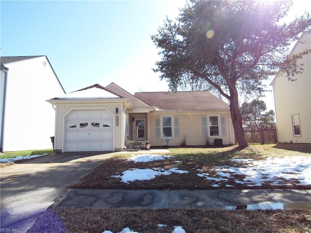 single story home featuring a garage, concrete driveway, and fence