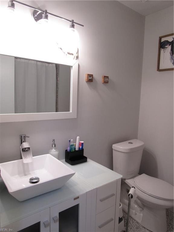 bathroom featuring toilet and vanity