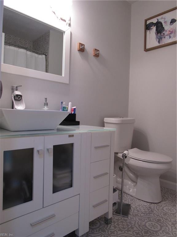 bathroom featuring vanity, toilet, and tile patterned floors