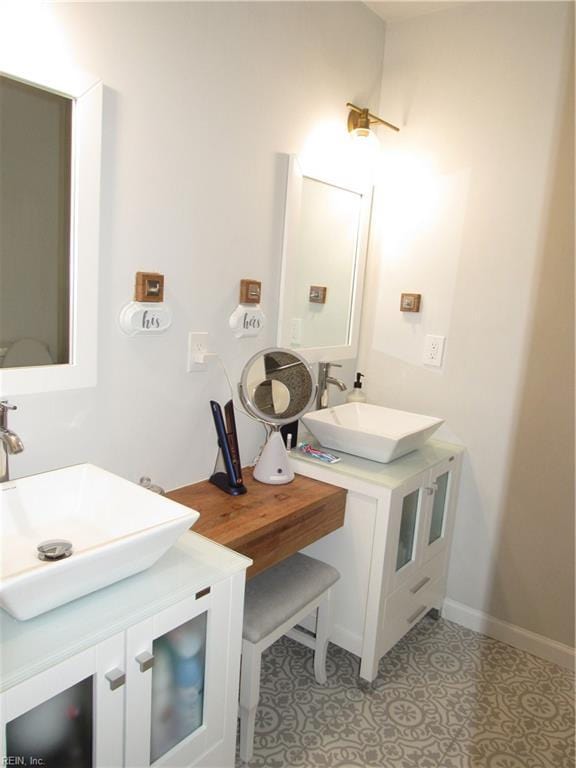 bathroom featuring double vanity, tile patterned flooring, and a sink