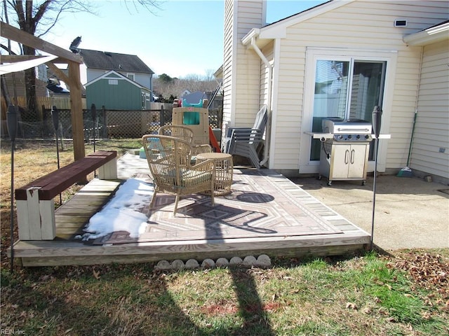 view of patio / terrace with grilling area, a playground, and fence