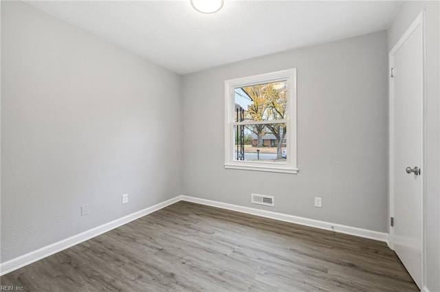 unfurnished bedroom with baseboards, visible vents, and wood finished floors