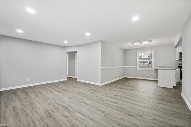 below grade area featuring recessed lighting, baseboards, and wood finished floors