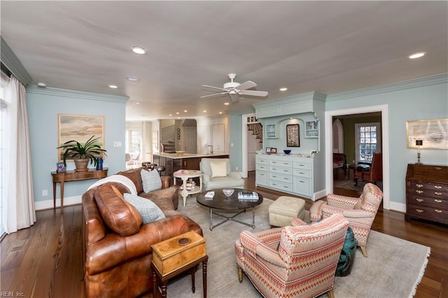 living room featuring crown molding, stairs, and a wealth of natural light