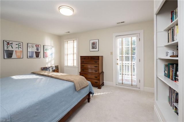 bedroom with access to exterior, light carpet, visible vents, and baseboards