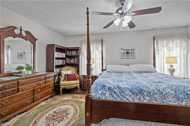 bedroom with a ceiling fan, multiple windows, and a textured ceiling