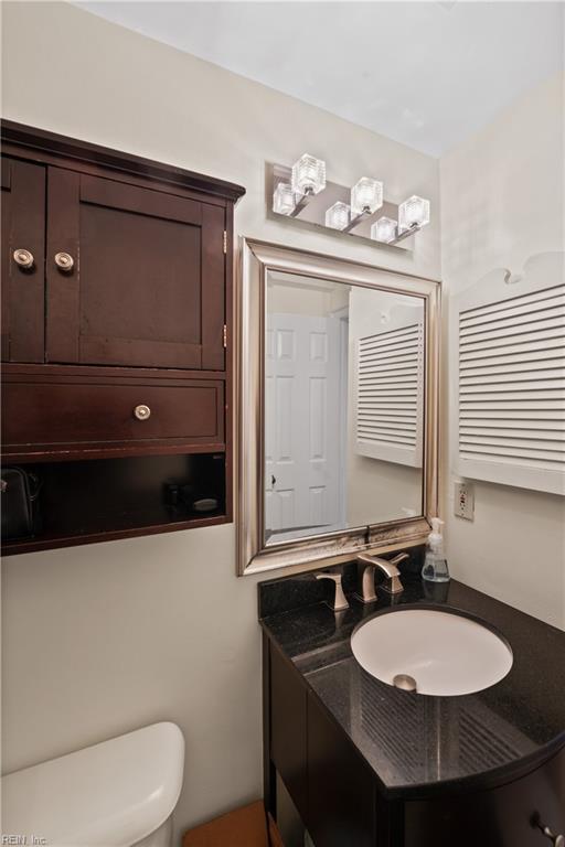 bathroom featuring vanity and toilet