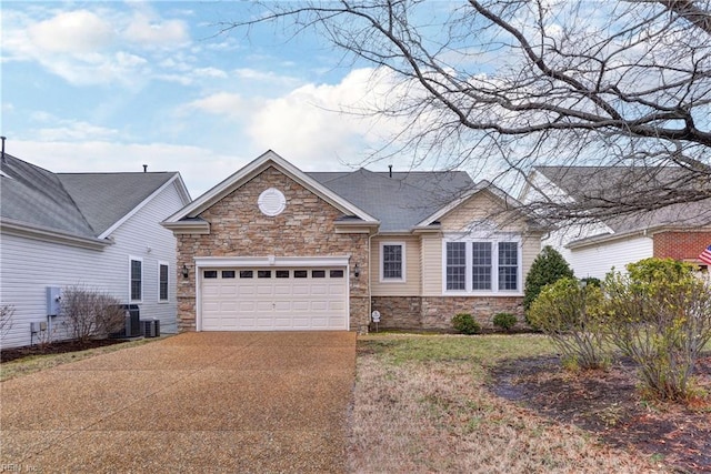 ranch-style home with an attached garage, stone siding, central air condition unit, and concrete driveway