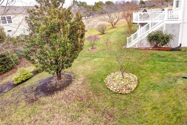 view of yard with stairway and a wooden deck