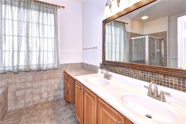 bathroom featuring double vanity, tile walls, a sink, and tile patterned floors