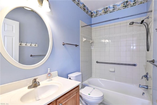 bathroom with toilet, vanity, and washtub / shower combination