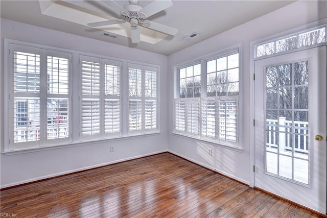 unfurnished sunroom with ceiling fan and visible vents