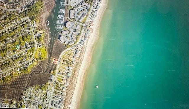 bird's eye view featuring a view of city, a water view, and a view of the beach