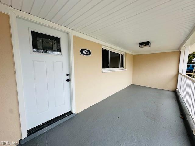 property entrance with stucco siding