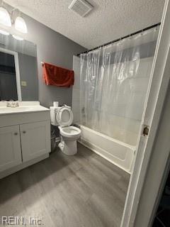 3536 Dublin Ct, Virginia Beach, VA 23453 - full bath with a textured ceiling, wood finished floors, shower / bath combo with shower curtain, and vanity