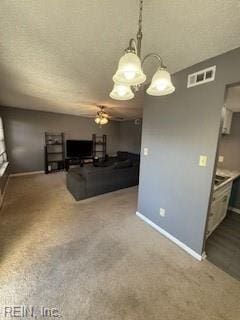 living area featuring carpet, visible vents, ceiling fan, a textured ceiling, and baseboards