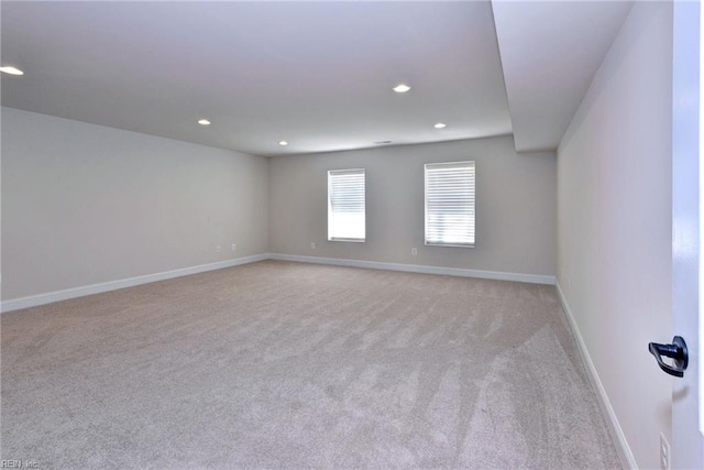 unfurnished room featuring light carpet, baseboards, and recessed lighting