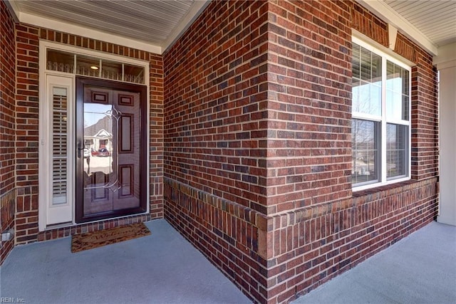 property entrance with brick siding