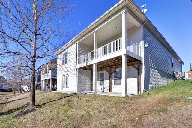 back of property featuring a yard and a patio