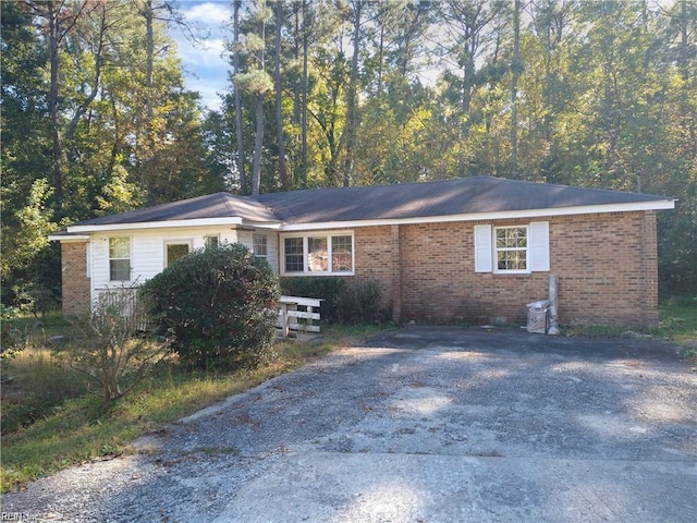 ranch-style house with driveway and brick siding