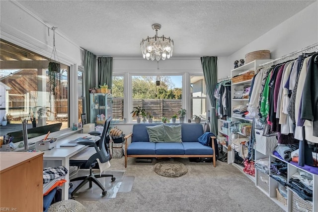 home office featuring a chandelier, a textured ceiling, and carpet flooring