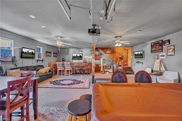 game room featuring a ceiling fan and finished concrete floors