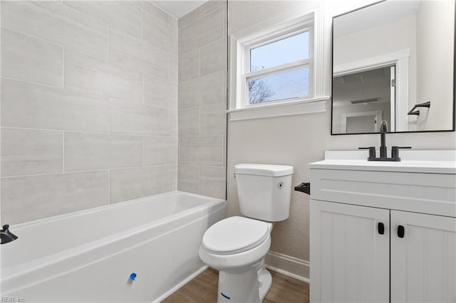 bathroom featuring baseboards, toilet, wood finished floors,  shower combination, and vanity