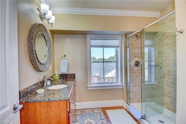 bathroom with a stall shower, baseboards, ornamental molding, and vanity