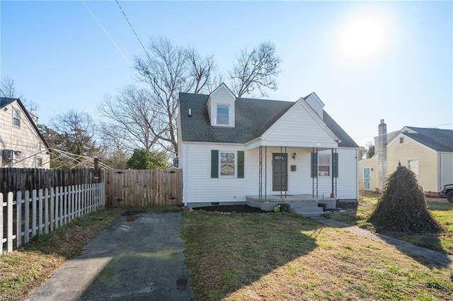 bungalow-style home featuring roof with shingles, covered porch, a front yard, crawl space, and fence