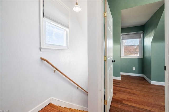 stairway with baseboards and wood finished floors