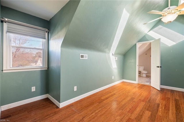 bonus room featuring visible vents, a ceiling fan, vaulted ceiling, wood finished floors, and baseboards