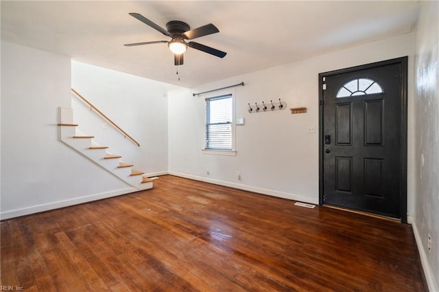 entryway featuring stairs, wood finished floors, a ceiling fan, and baseboards